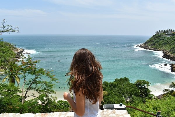 A guest looking out over the sea from a clifftop